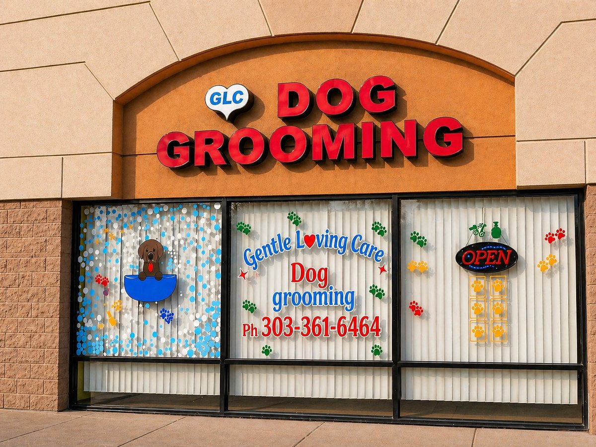 Storefront of Gentle Loving Care Dog Grooming in Aurora Colorado with the GLC heart logo, the red Dog Grooming sign, and decorated front windows showing a Labrador in a bath tub and the phone number 303-361-6464